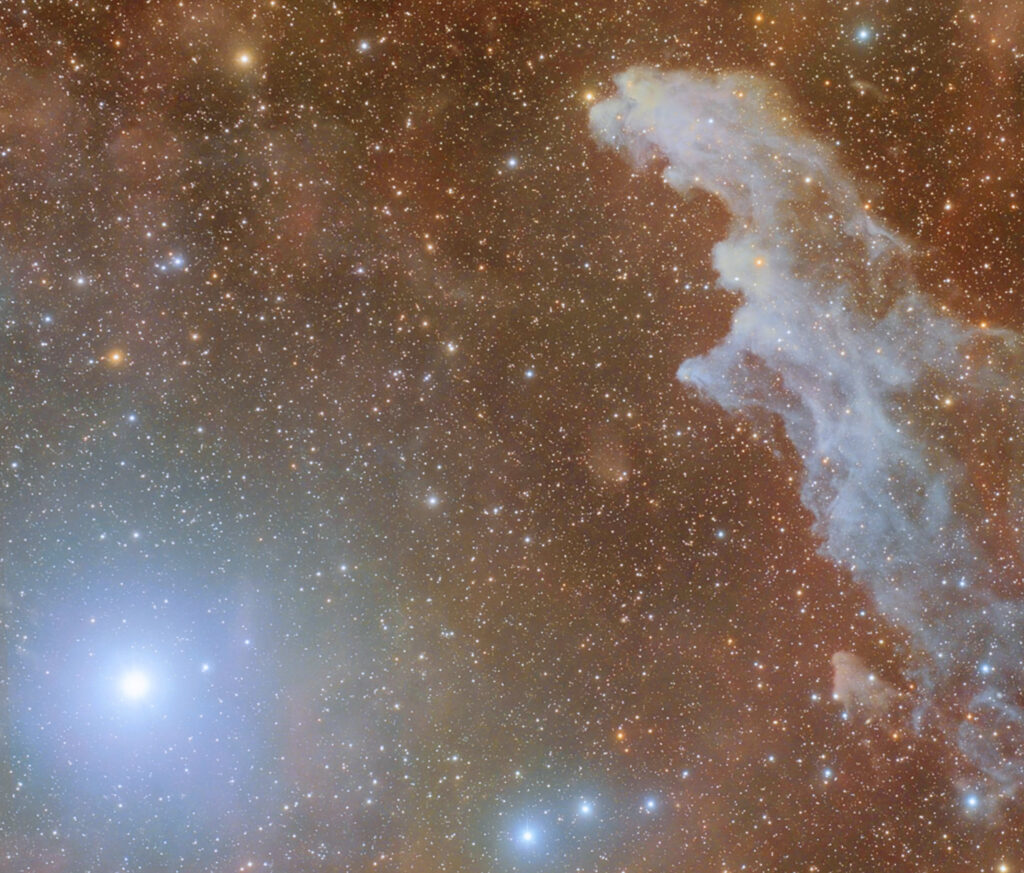 Rigel, luminosissima, in basso a sinistra, e la nebulosa Testa di Strega (IC 2118) sulla destra.